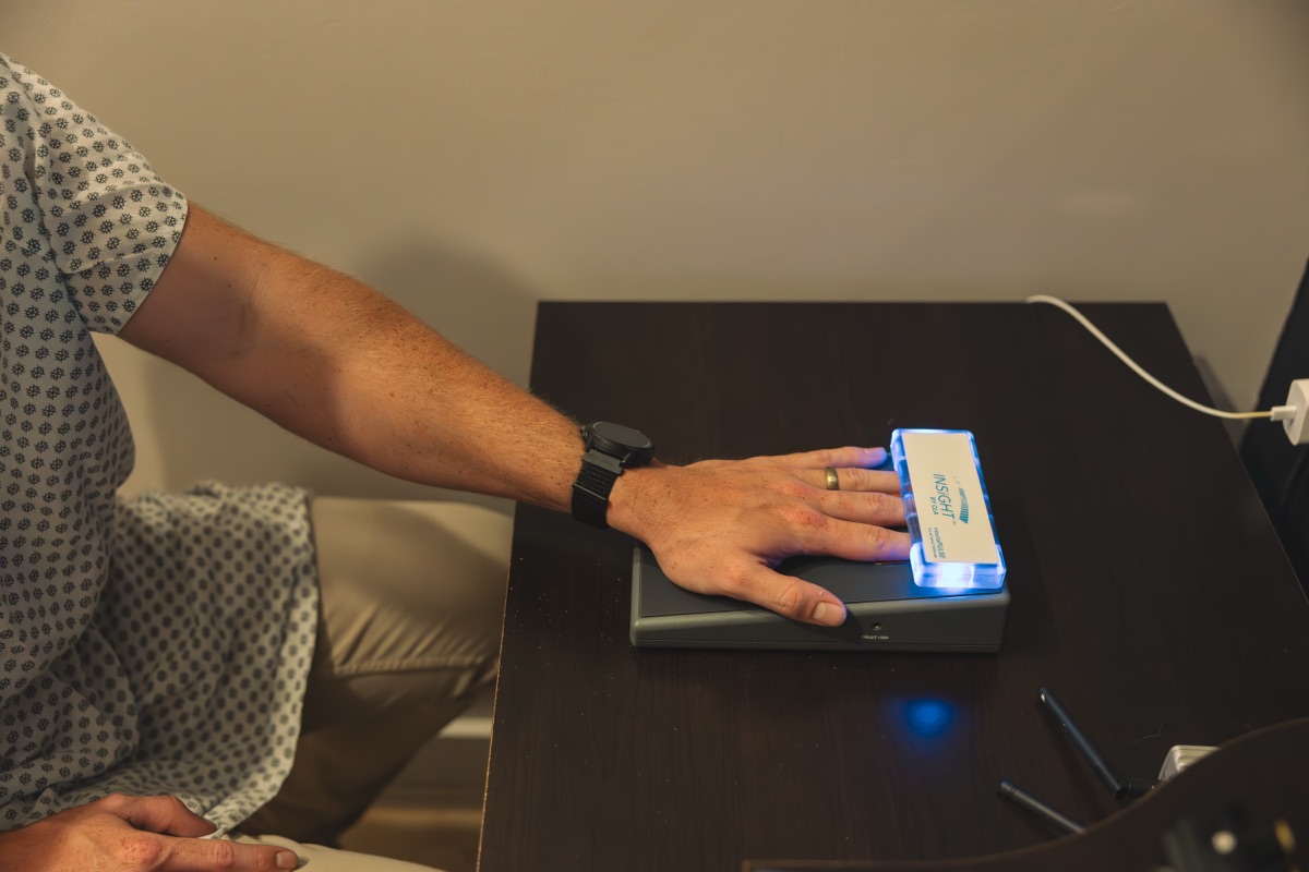 A heart rate variability scan in progress: a hand resting on the neuroPULSE sensor