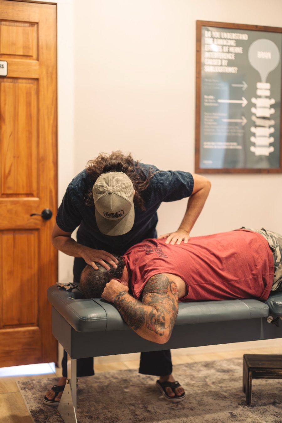 Dr. Dan performing an upper cervical adjustment on a patient lying face down