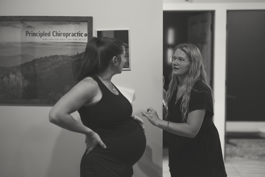 A prenatal consult in the exam room, in black and white