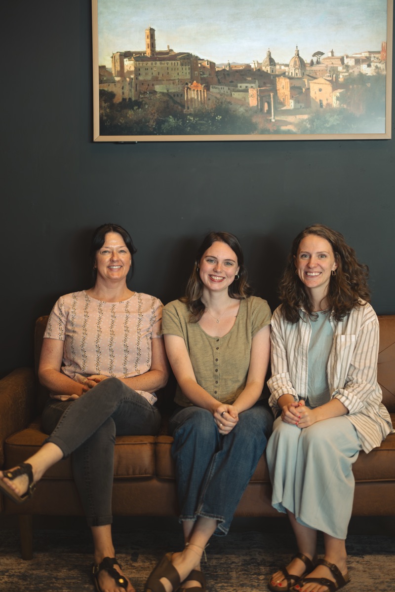 Mandy, Emily, and Gabriella on the leather couch in the Radius lobby