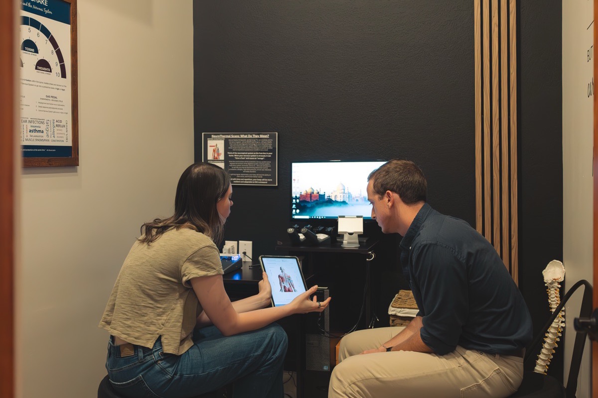 A doctor walking a patient through her scan results and care plan