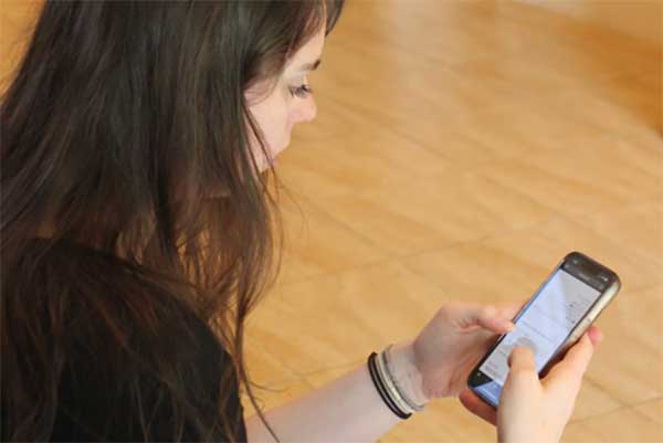 A patient completing her digital intake forms on her phone